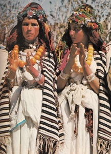 97121462_large_Berber_girls_clap_to_the_rhythm_of_village_musicians_at_a_festival_in_the_Atlas_Mountains_The_distinctively_striped_wool_shawls_they_wear_identify_their_clan_affiliation